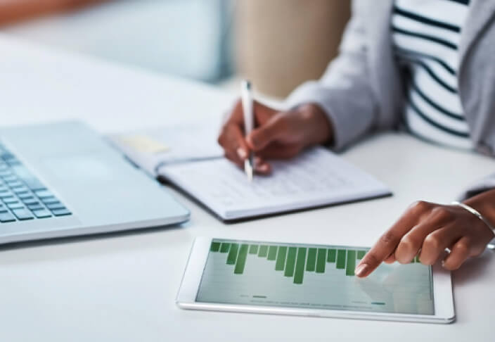 Woman pointing to data on a tablet screen