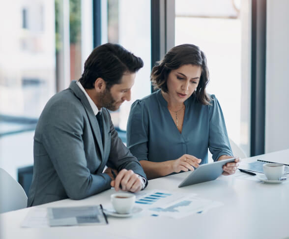 Man and woman business professionals reading data