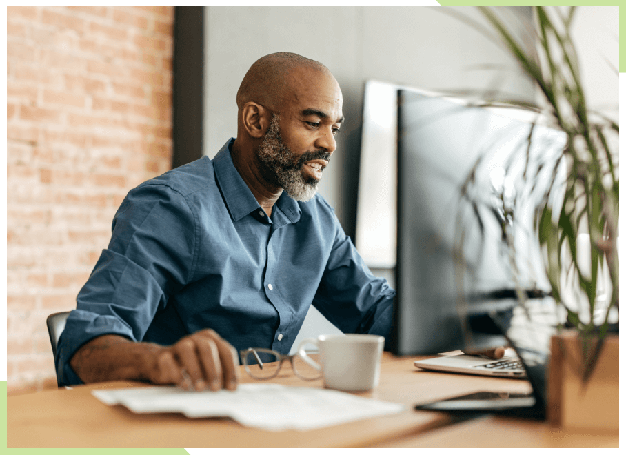 Man working at a table with a desktop computer