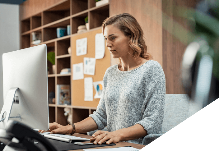 Woman using desktop computer in an office space