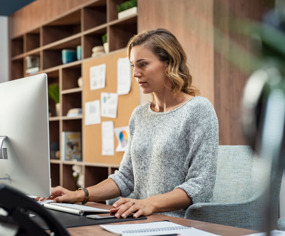 Woman using desktop computer in an office space