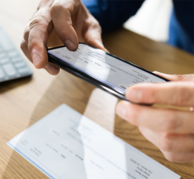 Man scanning check on table