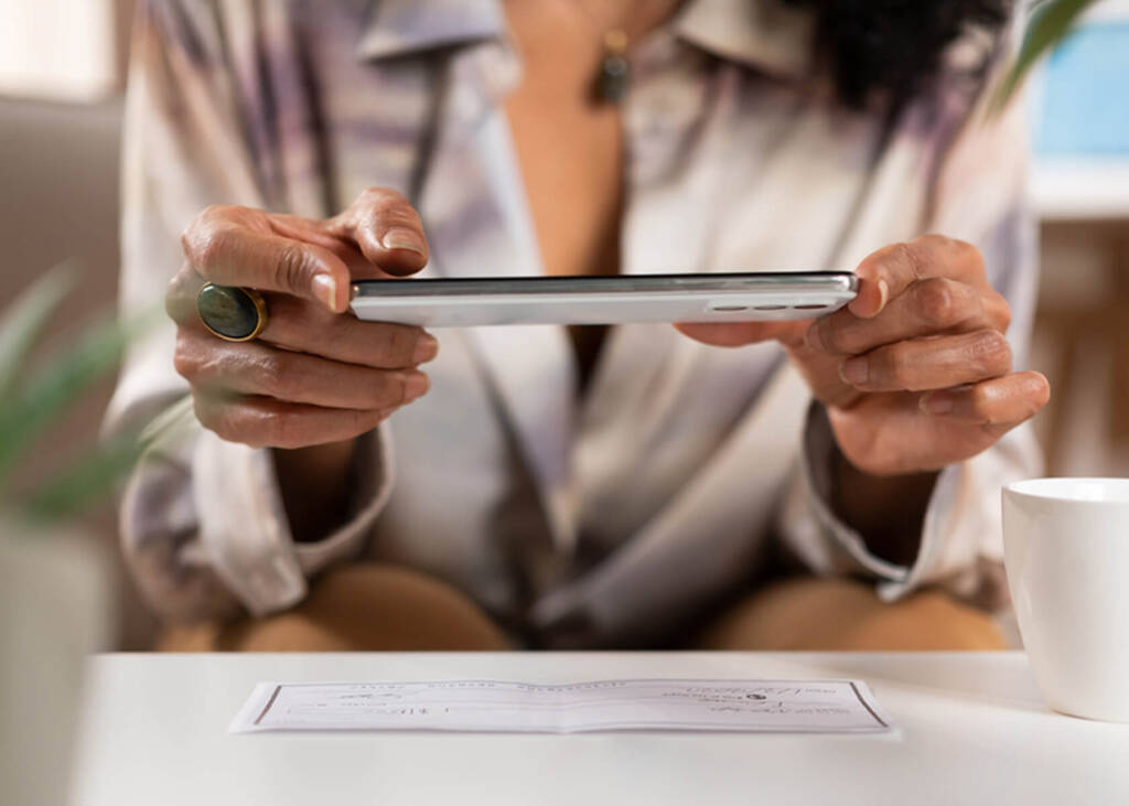 Woman scanning a check on a table