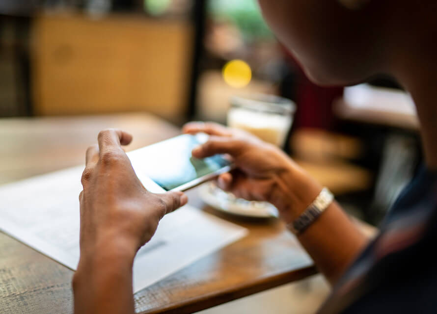 Woman's hands scanning a paper document on the table